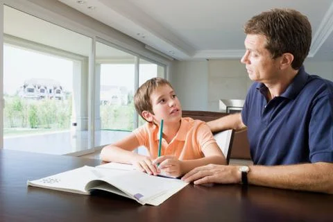 Father helping son with homework 스톡 사진