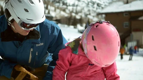 Father helps child put on ski gear on winter day at Alta Ski Area, Utah. Stock Footage 109190959