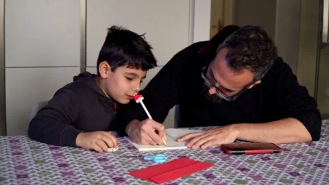 Father helps son to write a wishes list to Santa 스톡 동영상 345253445