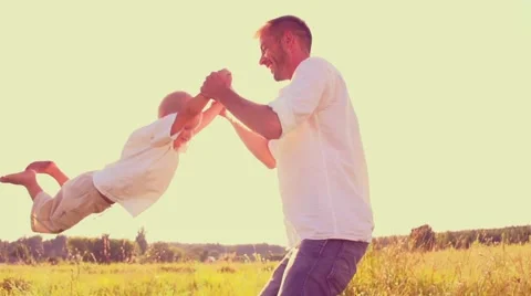 Father with his little son playing together, dad and child having fun outdoors. Stock Footage