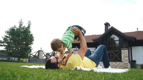 Father with his small son playing in the grass on the summer park. Stock Footage 78888591