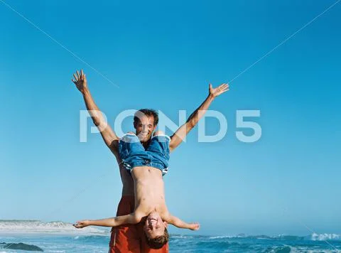 Father Holding Son Upside Down