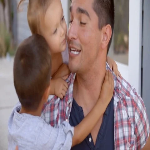 Father Hugging Children Sitting On Steps Outside Home Video stock 69386445