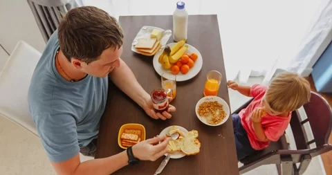Father with kid having breakfast together Stock Footage 101359896