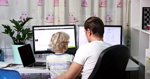 Father with kid trying to work from home during quarantine. Stock Footage 168940788