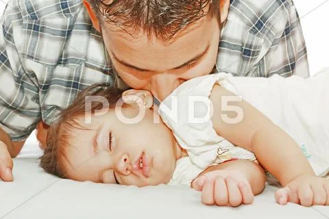 Father kissing his baby sleeping Stock Photos