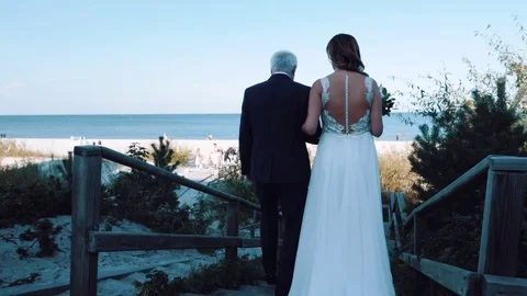 Father leads a daughter/bride to the wedding altar for a wedding ceremony on the Stock Footage