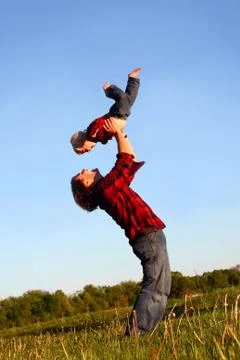 Father lifting son Stock Photos