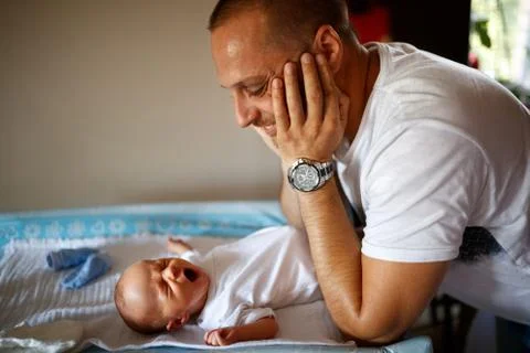 Father looking his child while crying Stock Photos