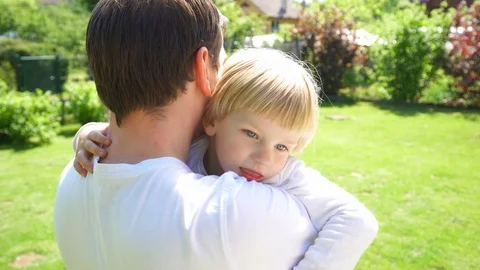 Father man try to calm down hyperactive son boy. Handheld motion shot. Stock Footage 117344163