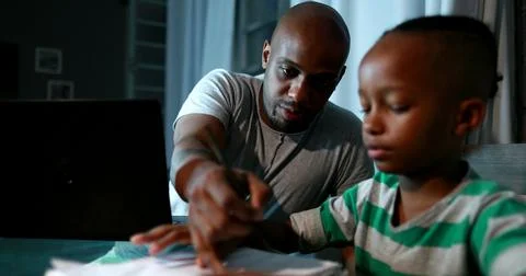 Father multi-tasking using computer laptop at home. Candid authentic and real Foto stock