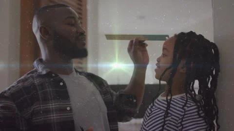 Father placing ruler on daughter's head, marking wall while height line Stock Footage 330893765