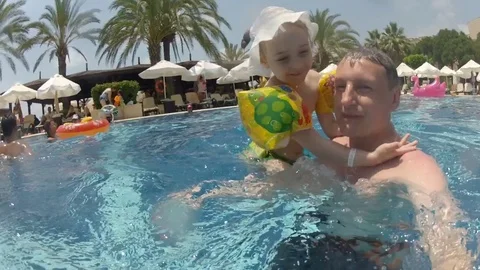 Father play and has fun with happy young child daughter in pool. Time lapse. Stock Footage 81096101