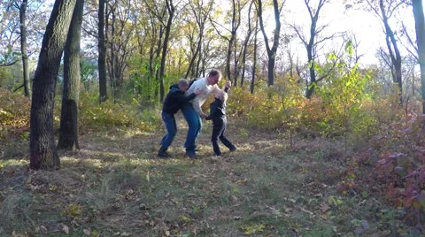 Father played with two young sons in the autumn forest. Stock Footage 56574847