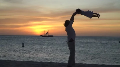 Father playing and dancing with his toddler daughter in Caribbean beach on Stock Footage 240204347