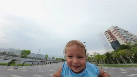 Father playing with his son in the park. Father spinning around his adorable 스톡 동영상 196980472