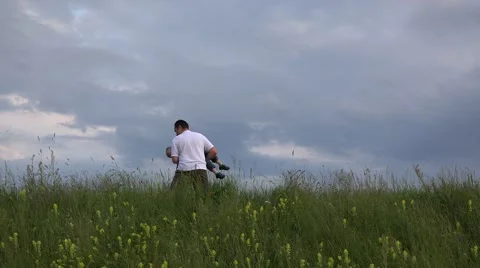 Father playing with his son on spring park, dramatic sky 4K Stock Footage 46206103