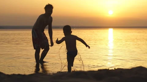 Father playing with son on sunset background Stock Footage 68016173