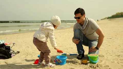 Father plays with daughter at the beach Stock Footage 63376532