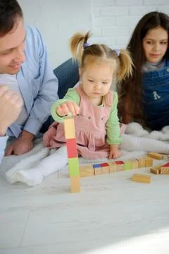 Father plays with two daughters. Stock Photos