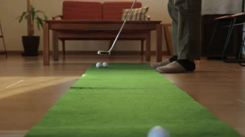 Father practicing putting at home. Stock Footage 224905282