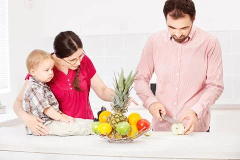 Father is preparing fruit for child Stock Photos