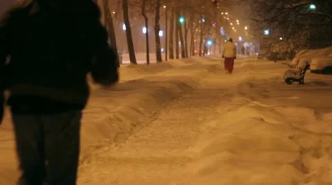Father Pulling Son On Sledge Along Snowy Street Stock Footage 12677968