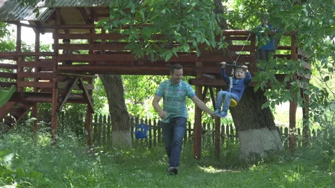 Father pulls little kid on zip line sliding Video stock 200862802
