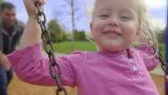 Father Pushes Happy Daughter On Swing Stock Footage