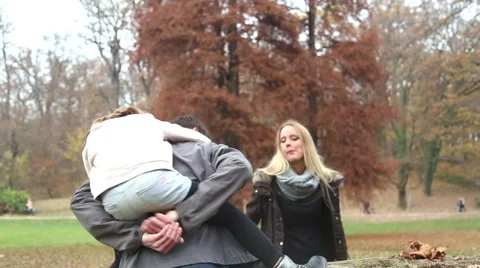 Father putting daughter on tree stump Stock Footage 59553997