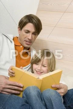 Father reading to son (8-9) portrait Stock Photos