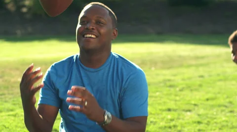 A father rest as he was plays football with his kids Stock Footage 33846989