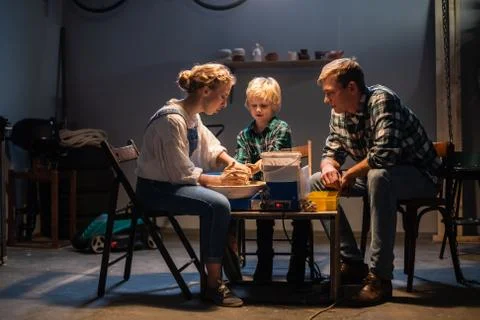 The father sends his son to study pottery, together with a young teacher, they Stock Photos