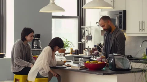 Father serving breakfast to his daughters in kitchen Stock Footage 63860945