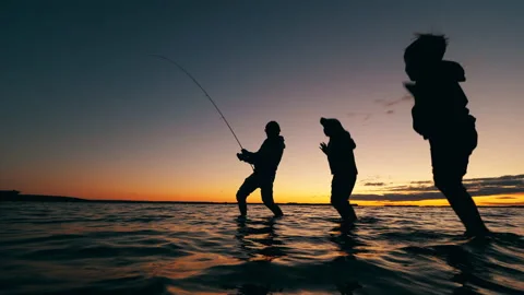 Father is showing his sons how to catch ... | Stock Video | Pond5