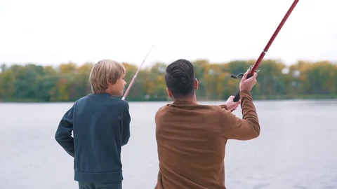 Father shows son how to fish Stock Footage 80839516