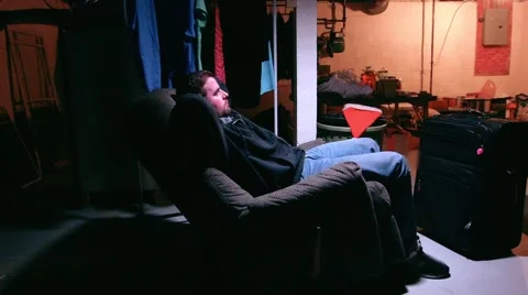 A Father sits on a couch Stock Footage 52792279
