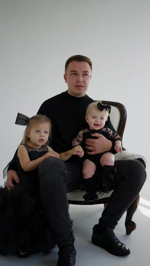 Father is sitting with two small children. Concept of family ties. Stock Footage 290507737