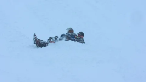 Father Sledding with Two Boys through Deep Snow Stock Footage 102928232