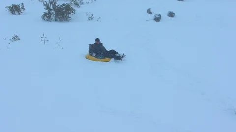Father Sledding with Two Boys through Fresh Snow Stock Footage 102932770