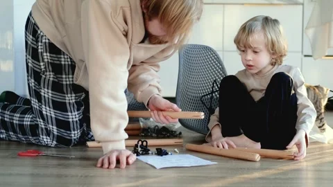 Father with son and cat assembling a chair 스톡 동영상 305947085