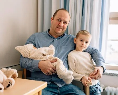 Father with Son and Newborn Stock Photos