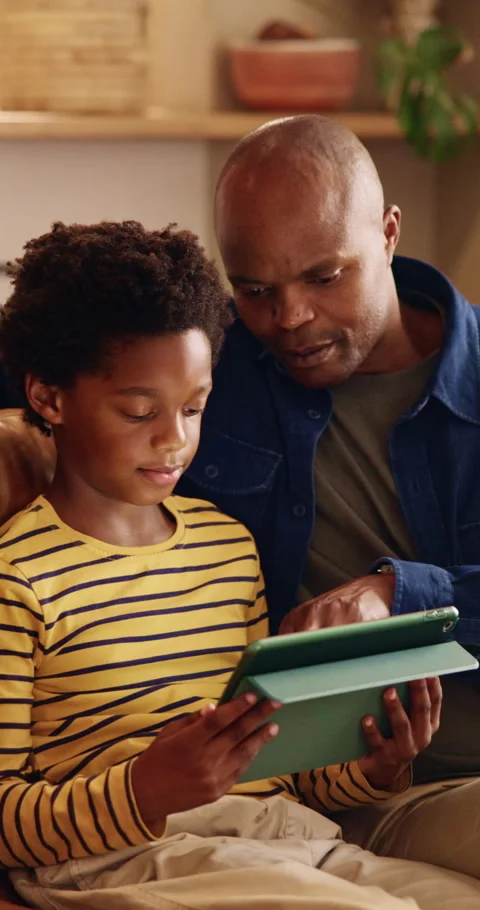 Father, son and tablet on sofa for elearning, bonding and educational app in Stock Footage 343208506