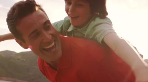 Father with son on back playing in countryside. Stock Footage 43670110