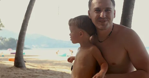Father with son on beach Stock Footage 106798102