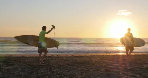Father &amp; son getting ready to surf at durban beach Stock Footage 80591877