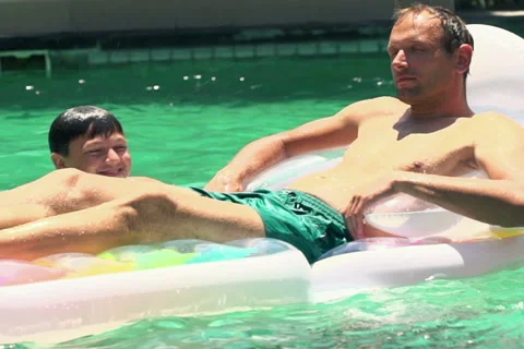 Father with son having fun in swimming pool, slow motion NTSC Stock Footage 46571653