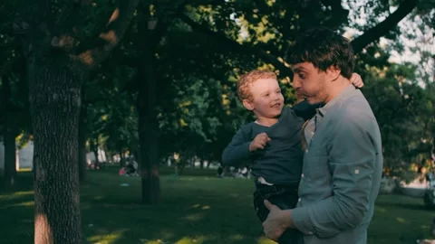Father with son play in the park in spring. Happy family. Slow motion Stock Footage 245270468
