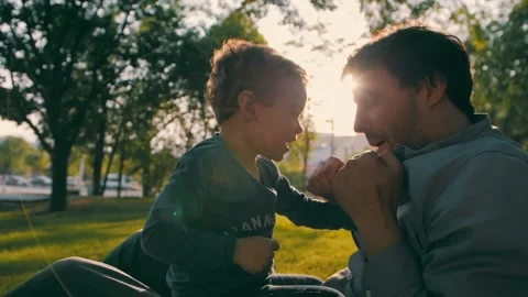 Father with son play in the park in spring. Happy family. Slow motion Stock Footage 245270538