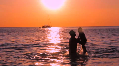 Father with son playing in the sea Stock Footage 64213106